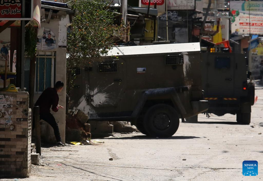 Palestinians confront Israeli forces during clashes at refugee camp in West Bank