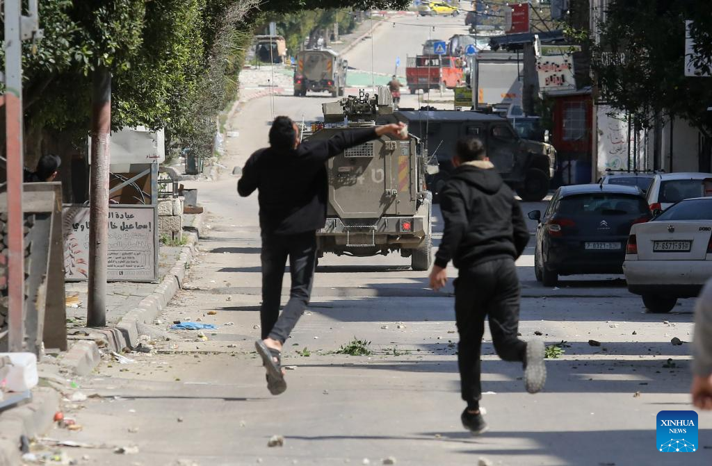 Palestinians confront Israeli forces during clashes at refugee camp in West Bank