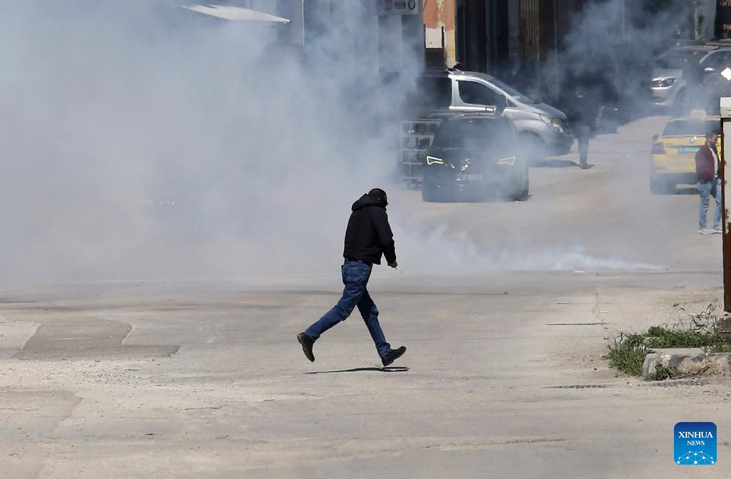 Palestinians confront Israeli forces during clashes at refugee camp in West Bank