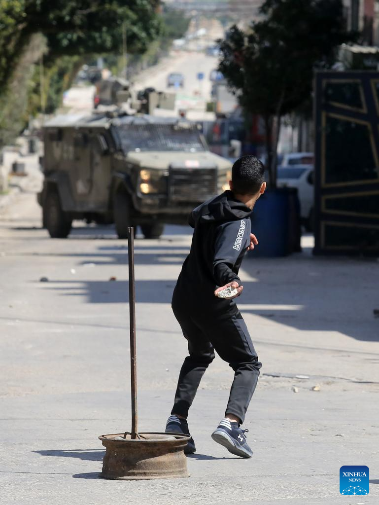 Palestinians confront Israeli forces during clashes at refugee camp in West Bank