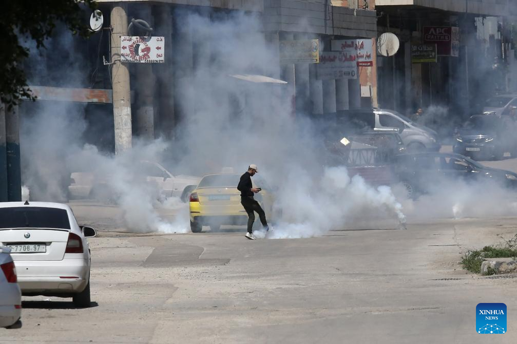 Palestinians confront Israeli forces during clashes at refugee camp in West Bank
