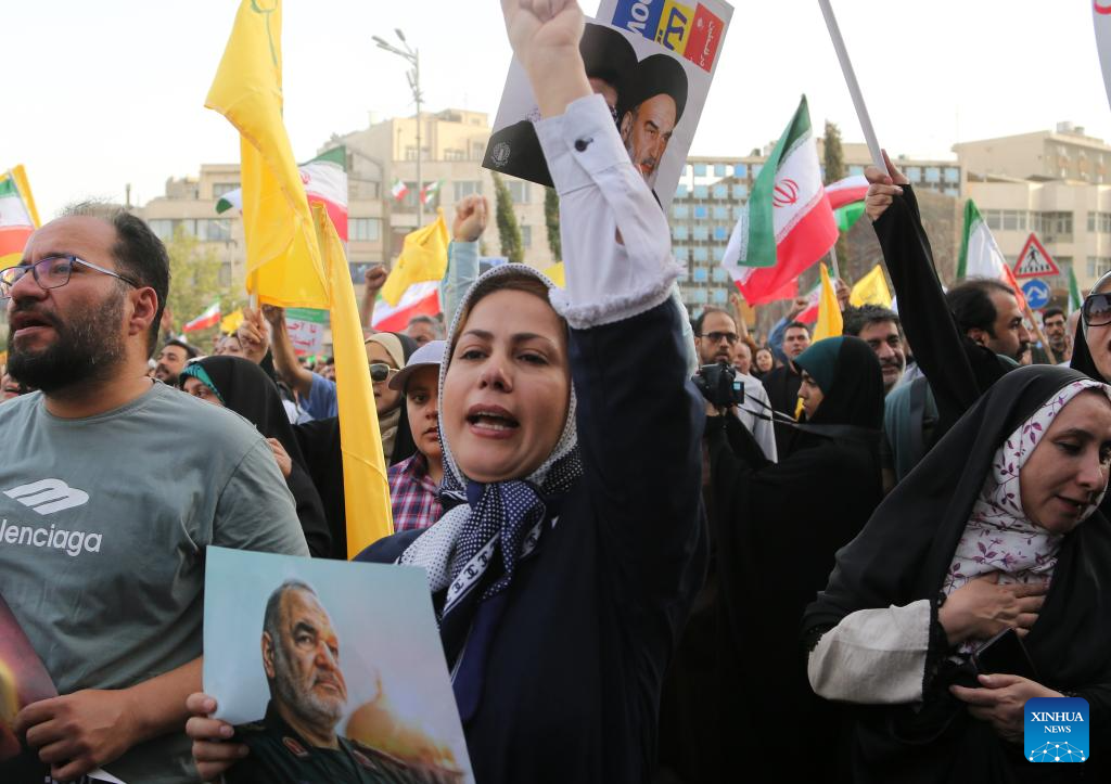 People celebrate ceasefire between Iran, Israeal at Enghelab Square in Tehran