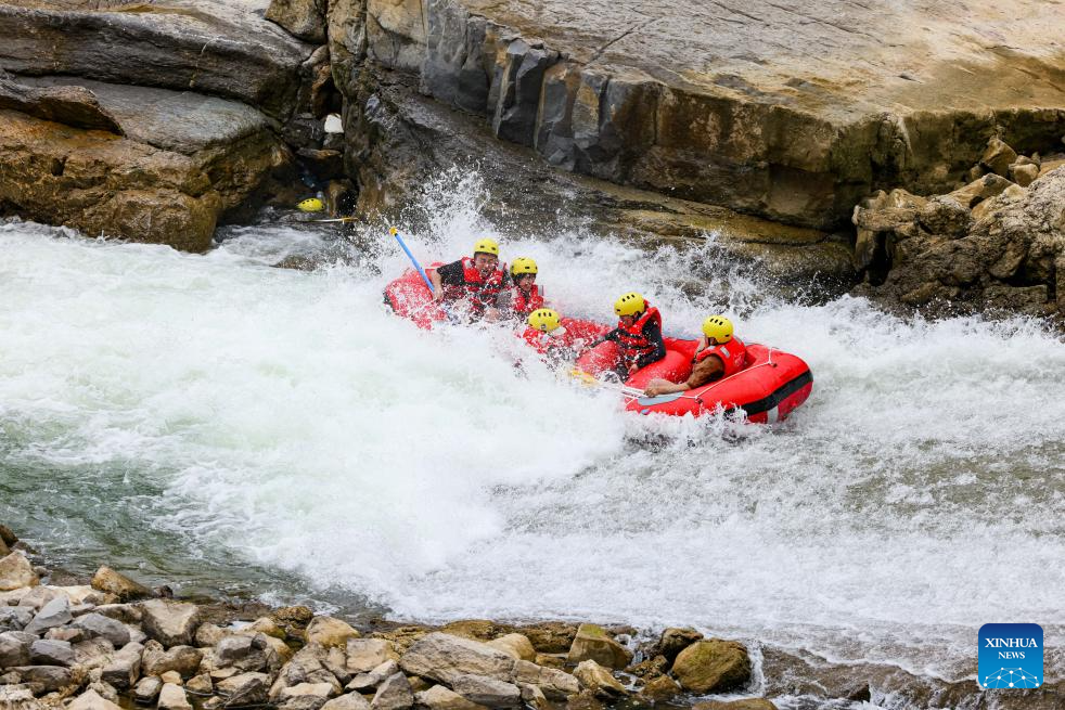 People raft in inflatable boats on Luobei River in Guizhou