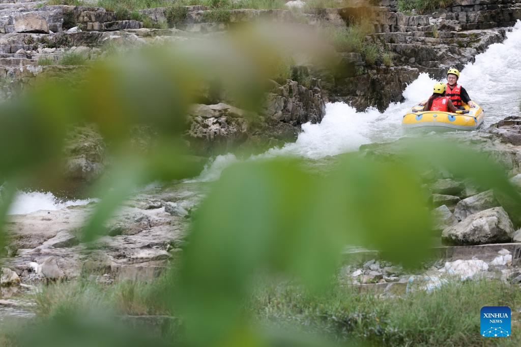 People raft in inflatable boats on Luobei River in Guizhou