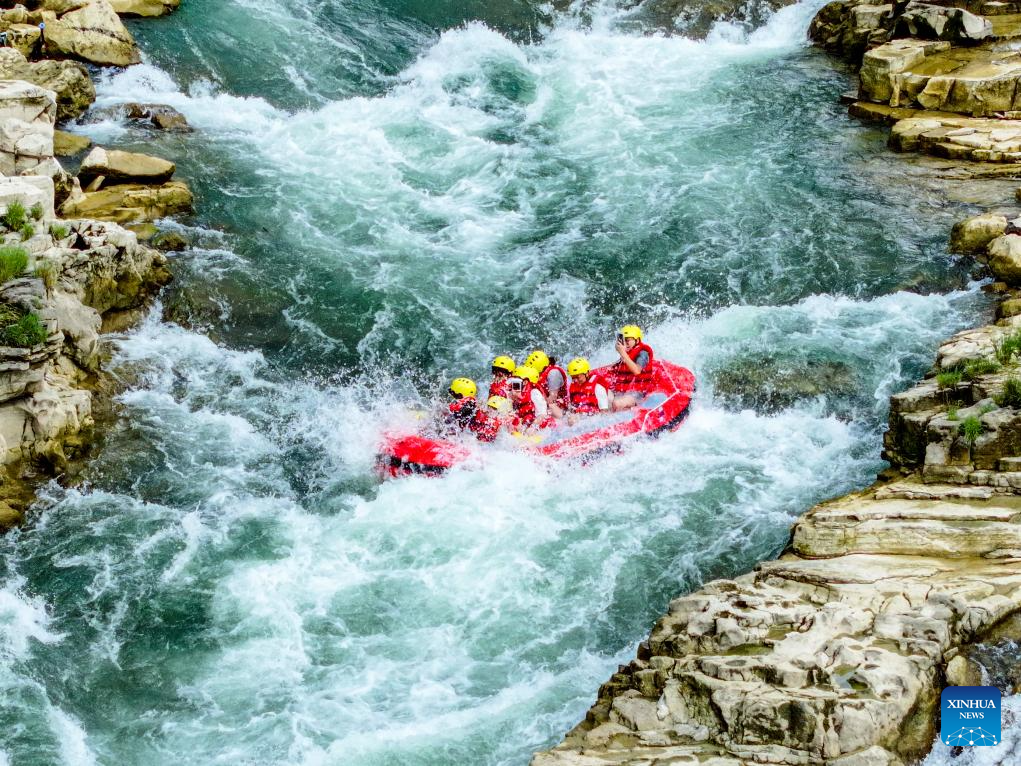 People raft in inflatable boats on Luobei River in Guizhou