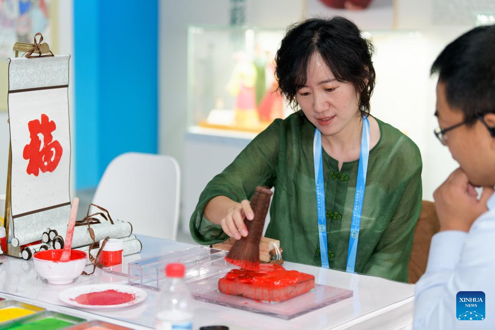 A glimpse of intangible cultural heritage experience zone at press center of SCO Summit 2025 in Tianjin