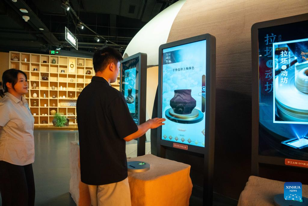 People visit Wuxi Intangible Cultural Heritage Park in Huaihua, China's Hunan