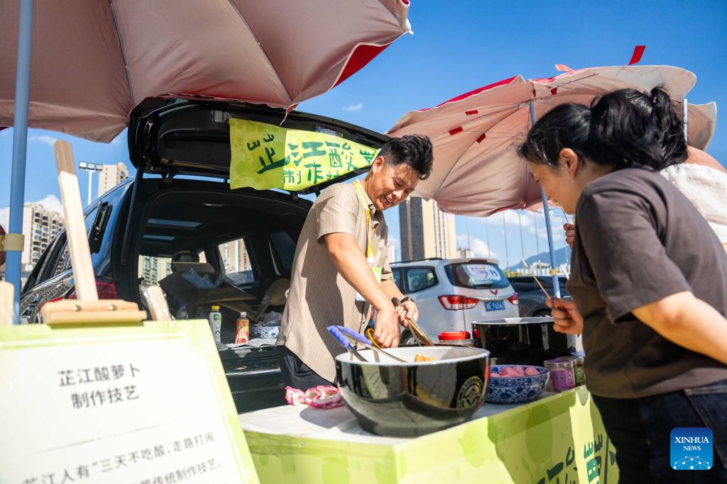 People visit Wuxi Intangible Cultural Heritage Park in Huaihua, China's Hunan