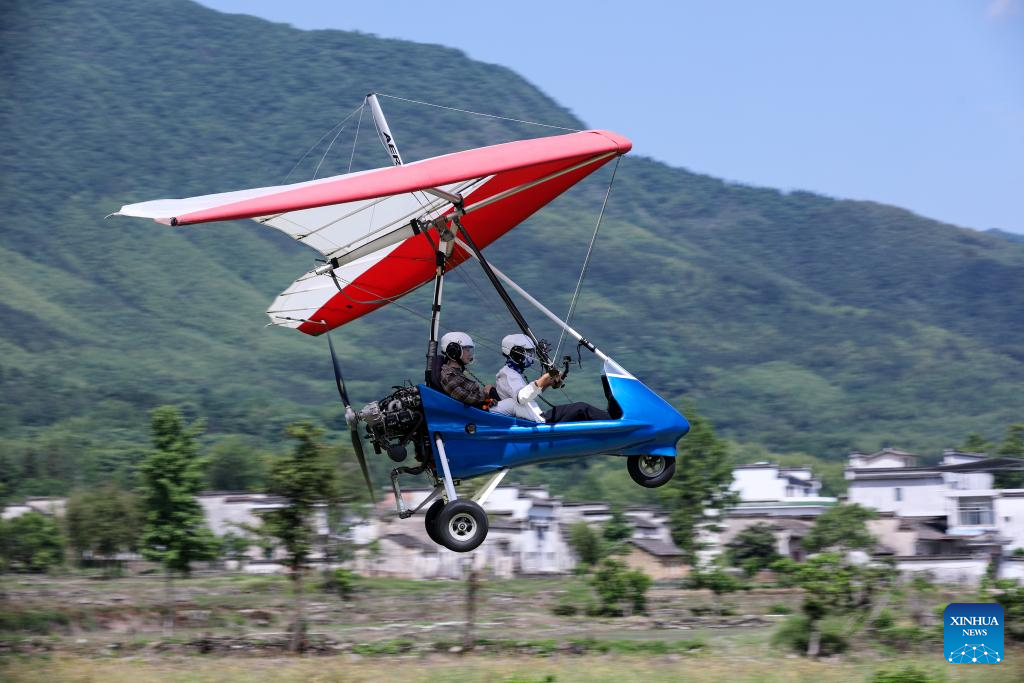 Tourists enjoy immersive aerial experience in Hongcun Village, E China