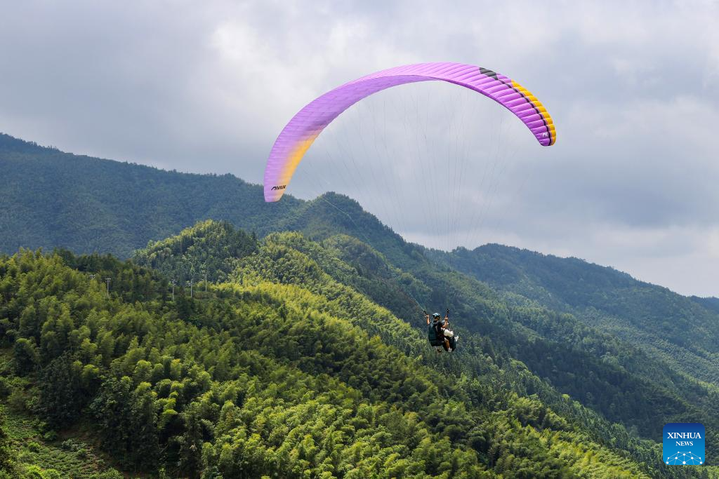 Tourists enjoy immersive aerial experience in Hongcun Village, E China