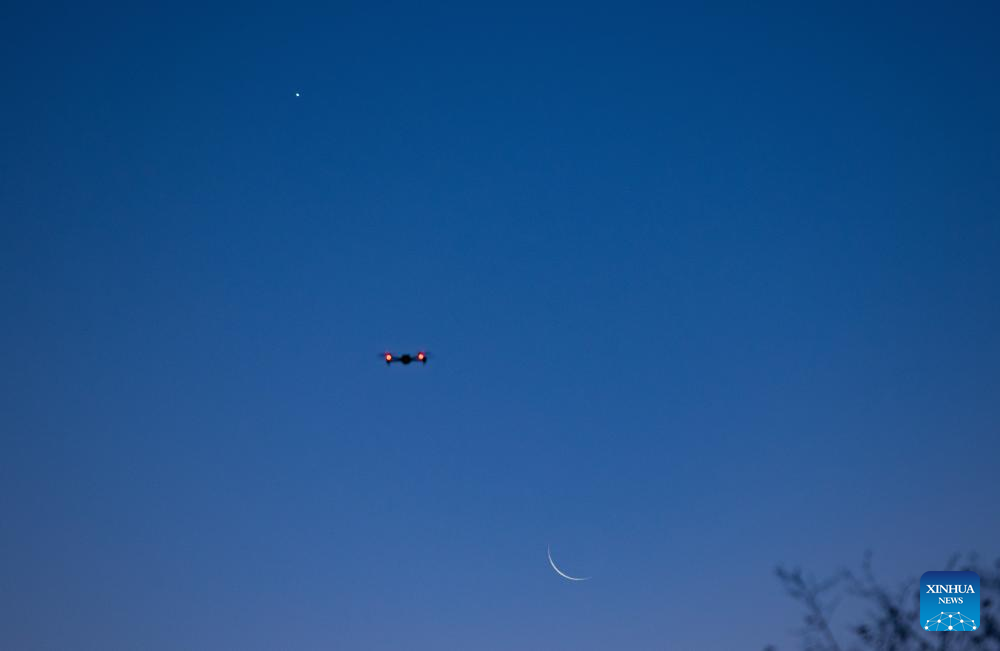 View of Venus next to moon in sky over NE China's Heilongjiang