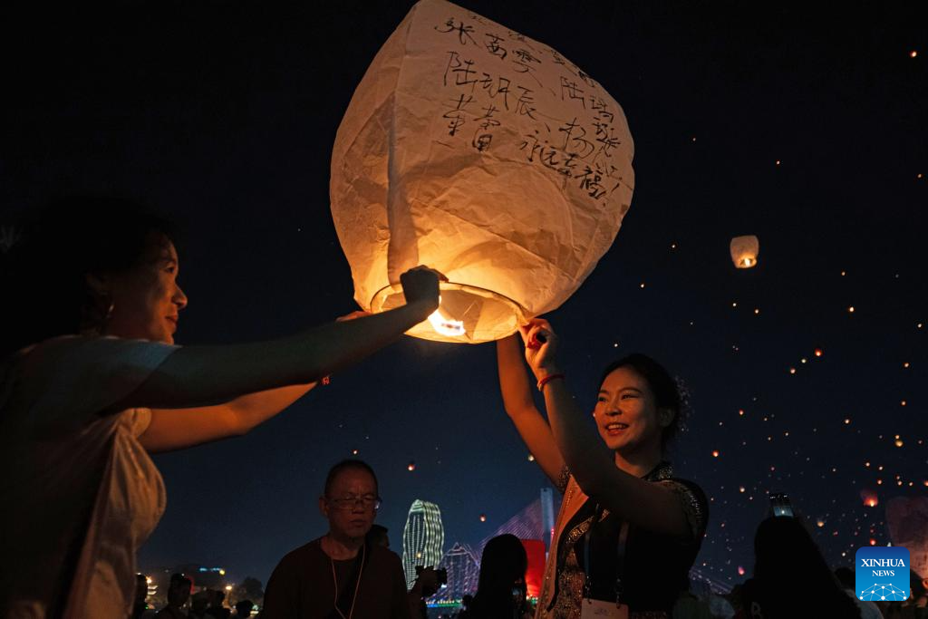 People fly Kongming lanterns in Jinghong, China's Yunnan