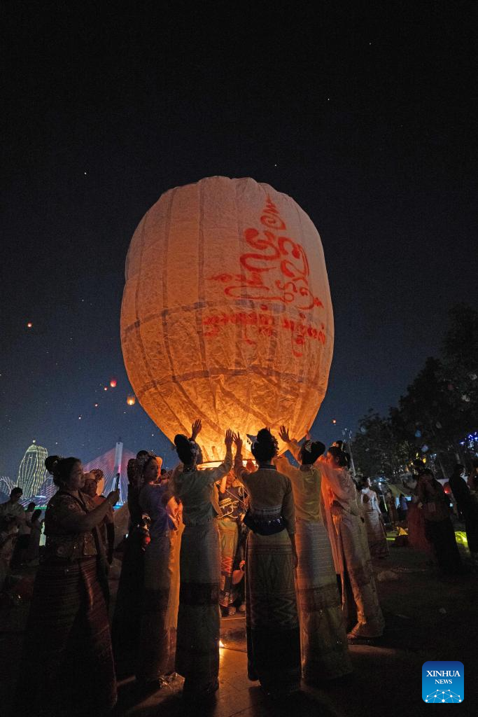 People fly Kongming lanterns in Jinghong, China's Yunnan