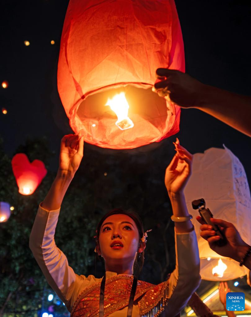 People fly Kongming lanterns in Jinghong, China's Yunnan