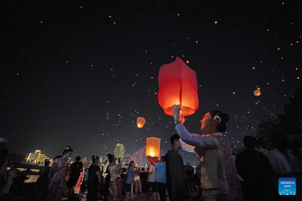 People fly Kongming lanterns in Jinghong, China's Yunnan