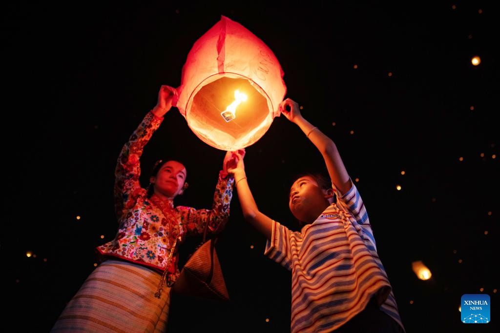 People fly Kongming lanterns in Jinghong, China's Yunnan