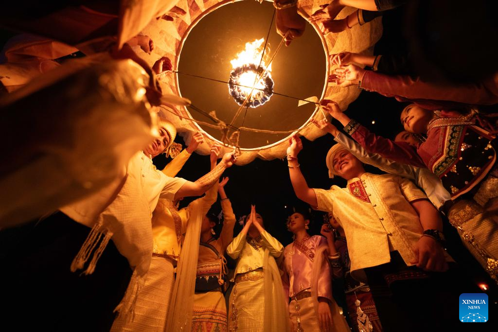 People fly Kongming lanterns in Jinghong, China's Yunnan