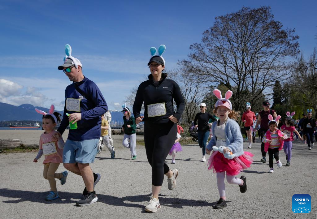 People take part in Big Easter Run at Jericho Beach in Canada