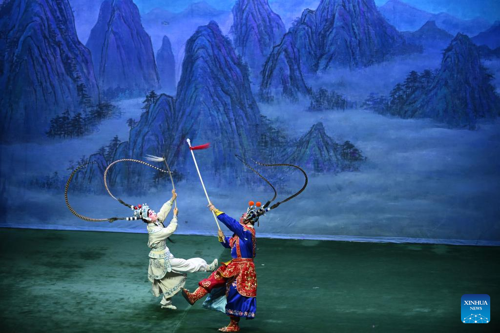 Artists perform Peking opera to mark